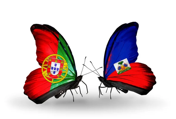 Butterflies with Portugal and Haiti flags on wings — Stock Photo, Image