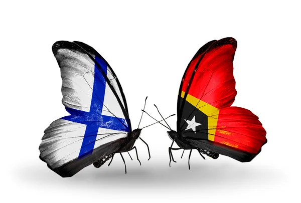 Motýli s Finskem a Východním Timoru vlajky na křídlech — Stock fotografie