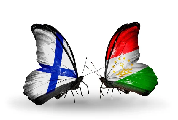 Kelebek kanatları üzerinde Finlandiya ve Tacikistan bayrağı ile — Stok fotoğraf