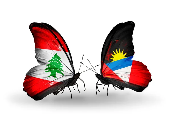 Бабочки с флагами Ливана, Антигуа и Барбуды на крыльях — стоковое фото