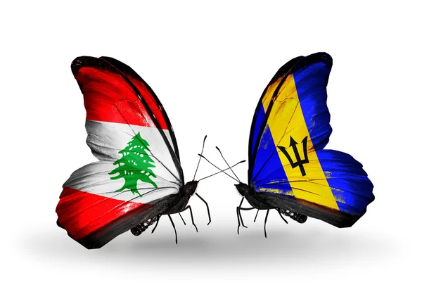 Vlinders met Libanon en barbados vlaggen op vleugels — Stockfoto