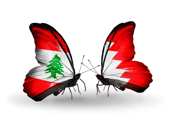 Vlinders met Libanon en Bahrein vlaggen op vleugels — Stockfoto