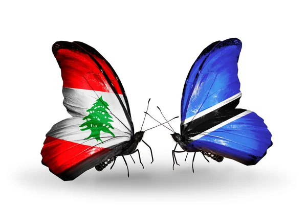 Butterflies with Lebanon and Botswana flags on wings — Stock Photo, Image