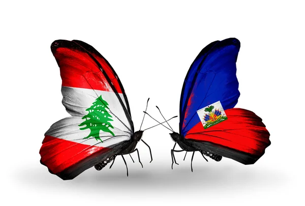Vlinders met Libanon en Haïti vlaggen op vleugels — Stockfoto