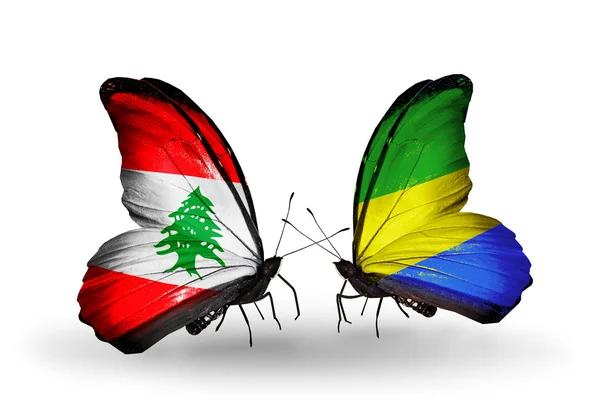 Butterflies with Lebanon and Gabon flags on wings — Stock Photo, Image