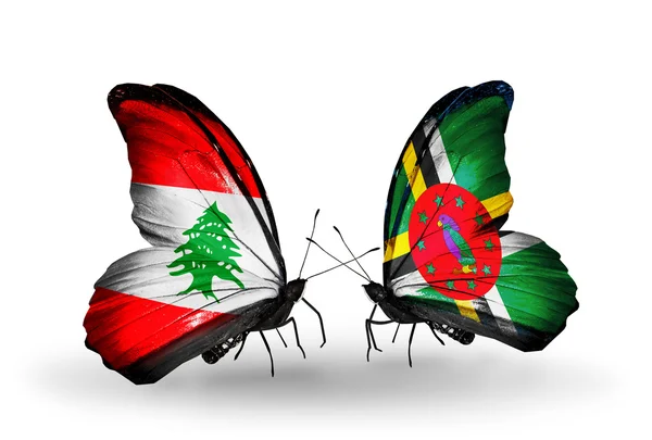 Farfalle con bandiere Libano e Dominica sulle ali — Foto Stock