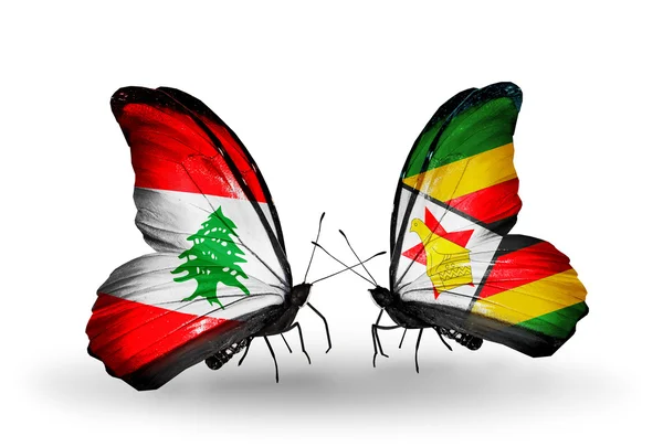 Schmetterlinge mit libanonischen und zimbabwischen Flaggen auf Flügeln — Stockfoto