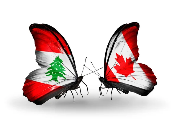 Vlinders met Libanon en canada vlaggen op vleugels — Stockfoto