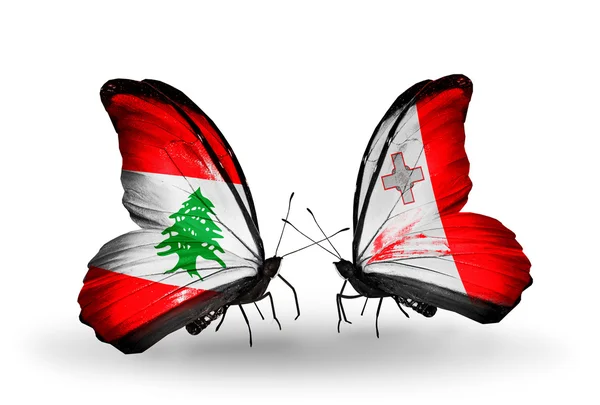 Butterflies with Lebanon and Malta flags on wings — Stock Photo, Image