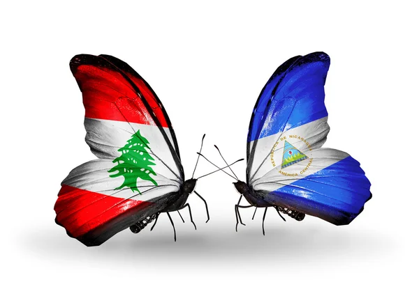 Motýli s Libanonem a Nikaragua vlajky na křídlech — Stock fotografie