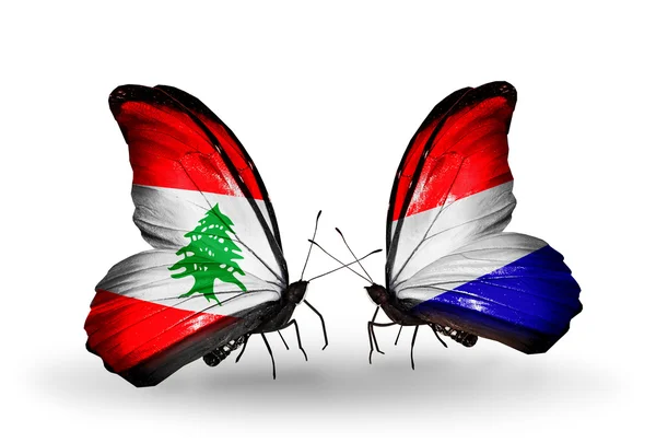 Butterflies with Lebanon and Holland flags on wings — Stock Photo, Image