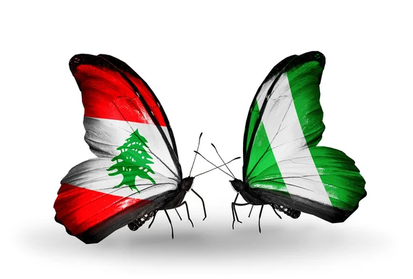 Butterflies with Lebanon and Nigeria flags on wings — Stock Photo, Image