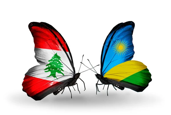 Vlinders met Libanon en rwanda vlaggen op vleugels — Stockfoto