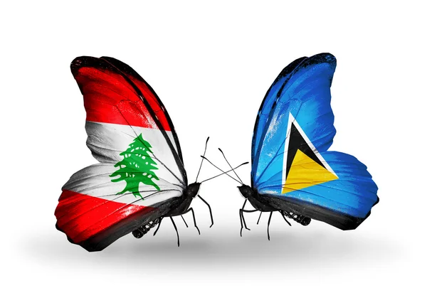 Papillons avec drapeaux Liban et Sainte-Lucie sur les ailes — Photo