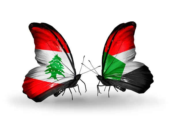 Borboletas com bandeiras do Líbano e Sudão em asas — Fotografia de Stock