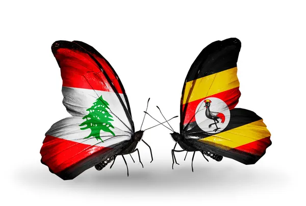 Borboletas com bandeiras do Líbano e Uganda em asas — Fotografia de Stock