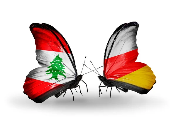 Butterflies with Lebanon and South Ossetia flags on wings — Stock Photo, Image