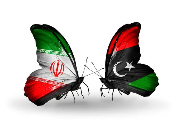 Zwei schmetterlinge mit fahnen der beziehungen iran und libyen — Stockfoto