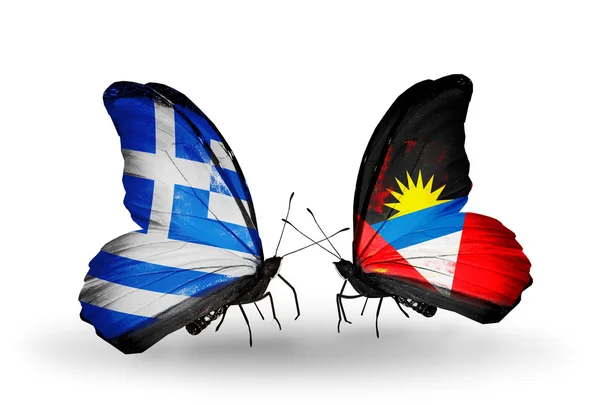 Fjärilar med flaggor av Grekland och antigua och barbuda — Stockfoto