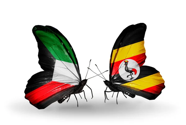 Dva motýli s vlajkami vztahů, Kuvajtu a Ugandy — Stock fotografie