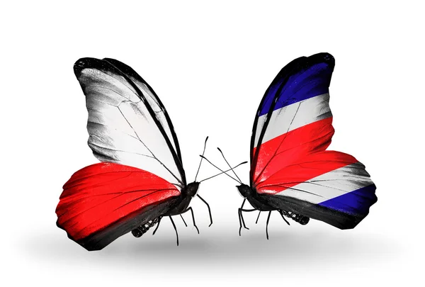 Dva motýli s vlajkami Polska a costa rica — Stock fotografie