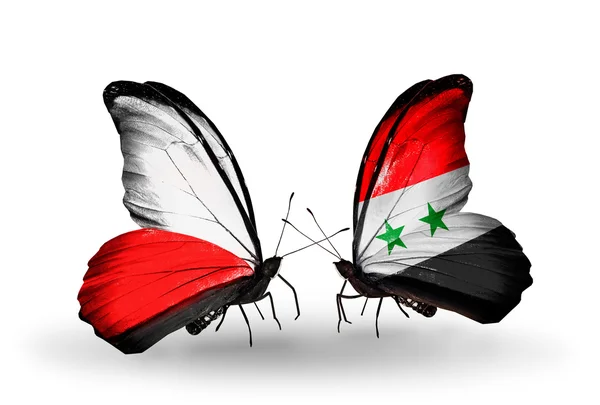 Deux papillons avec des drapeaux de Pologne et de Syrie — Photo