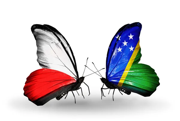 Dva motýli s vlajkami Polska a Šalamounovy ostrovy — Stock fotografie