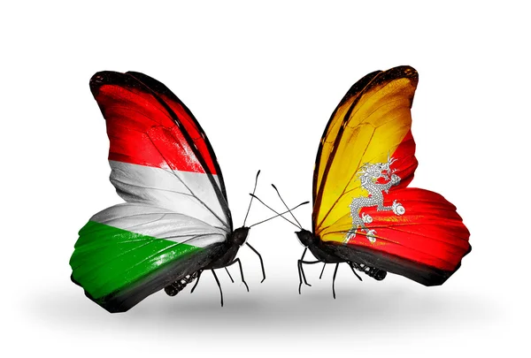 ハンガリーとブータンの国旗と 2 匹の蝶 — ストック写真