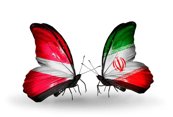 Dwa motyle z flagami i Łotwie Iranem — Zdjęcie stockowe