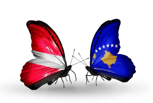 Duas borboletas com bandeiras da Letónia e kosovo — Stok fotoğraf
