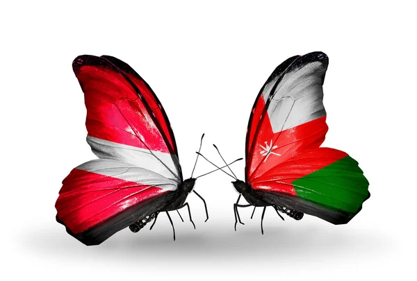 Motyle z flagami Łotwa i oman — Zdjęcie stockowe