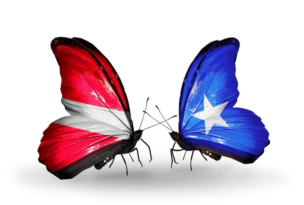 Mariposas con banderas de Letonia y Somalia — Foto de Stock