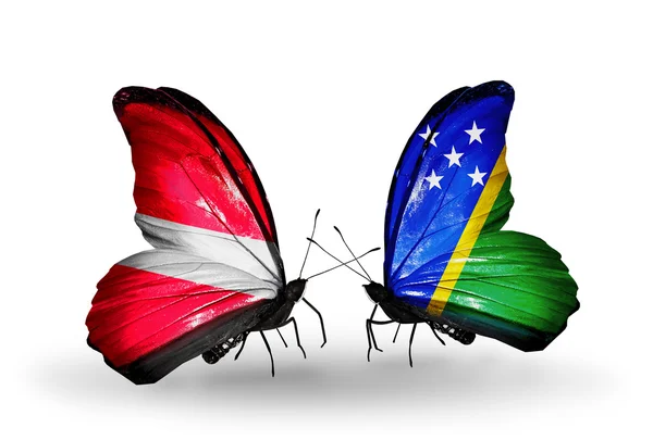 Butterflies with flags of Latvia and Solomon Islands — Stock Photo, Image