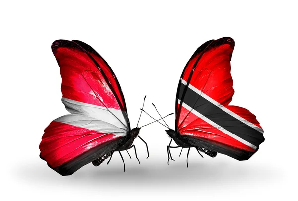 Motyle z flagami Łotwa i Trynidadu i tobago — Zdjęcie stockowe