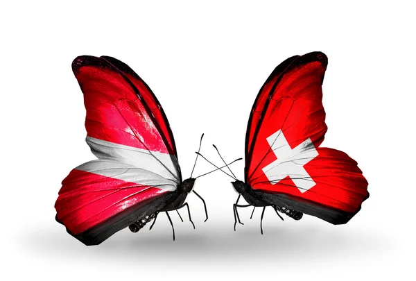 Mariposas con banderas de Letonia y Suiza — Foto de Stock