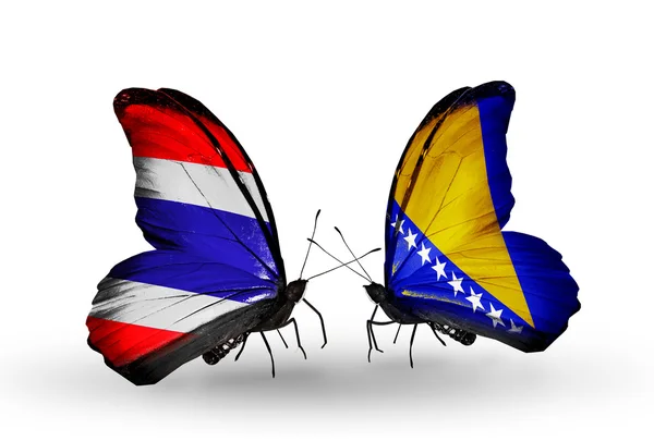 Zwei Schmetterlinge mit Fahnen von Thailand und Bosnien und Herzegowina — Stockfoto