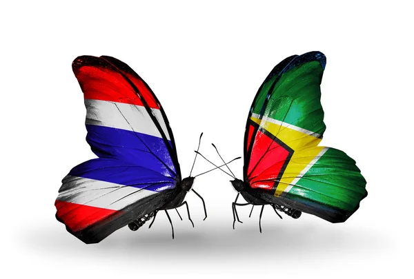 Two butterflies with flags of Thailand and Guyana — Stock Photo, Image