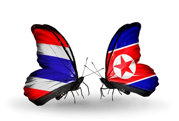 タイ、北朝鮮の国旗と 2 匹の蝶 — ストック写真