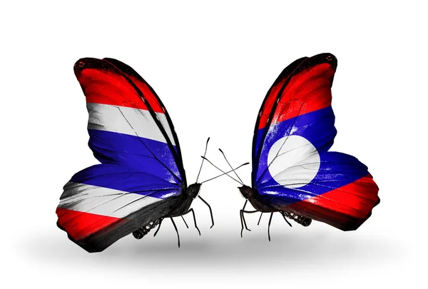 Twee vlinders met lijst van vlaggen van thailand en laos — Stockfoto