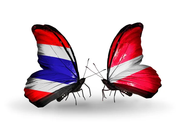 Twee vlinders met lijst van vlaggen van thailand en Letland — Stockfoto