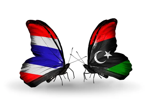 Dwa motyle z flagami w Tajlandii i Libii — Zdjęcie stockowe