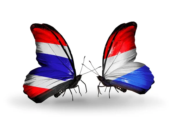 Twee vlinders met vlaggen van thailand en Luxemburg — Stockfoto