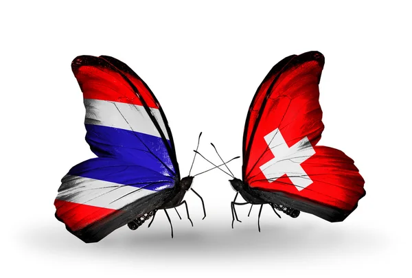 Butterflies with Thailand and Switzerland flags on wings — Stock Photo, Image