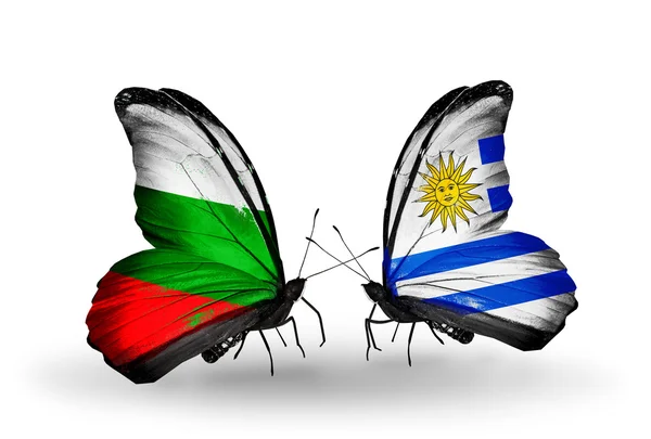 Borboletas com bandeiras da Bulgária e Uruguai em asas — Fotografia de Stock