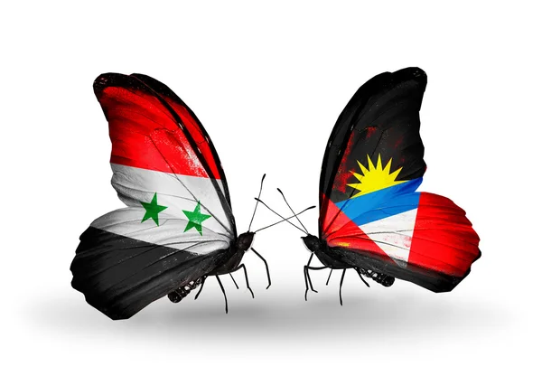 Butterflies with Syria and Antigua and Barbuda flags on wings — Stock Photo, Image