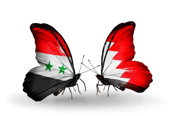 Butterflies with Syria and Bahrain flags on wings — Stock Photo, Image