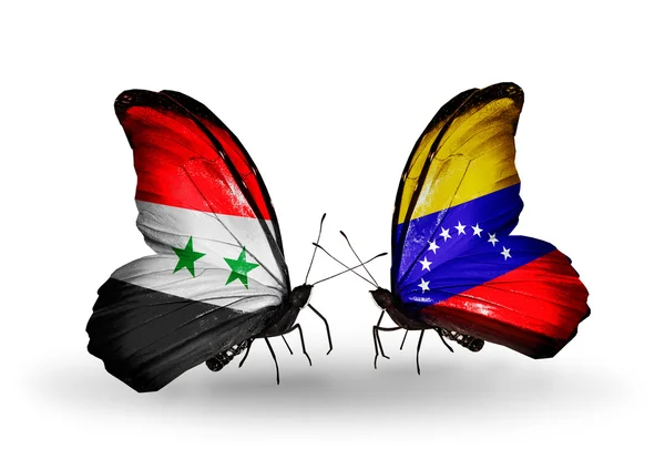Vlinders met Syrië en venezuela vlaggen op vleugels — Stockfoto