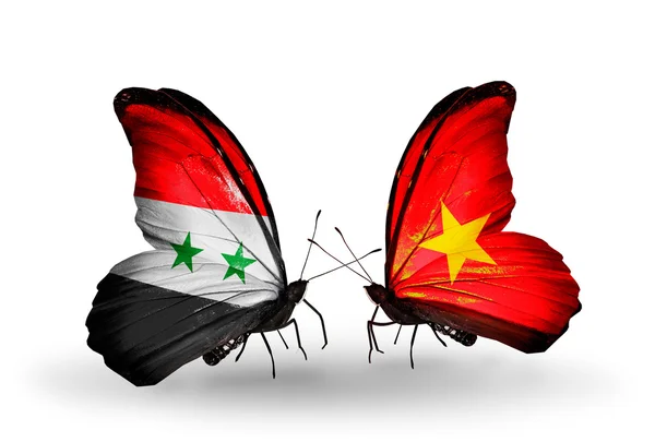 翼にシリアとベトナムのフラグと蝶 — ストック写真