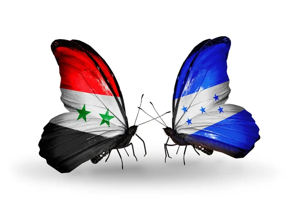Vlinders met Syrië en honduras vlaggen op vleugels — Stockfoto