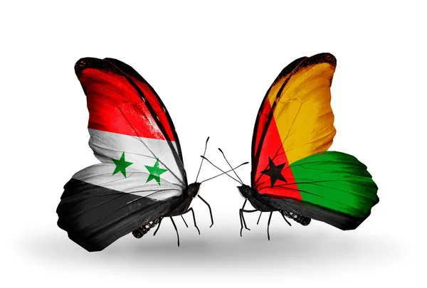 Butterflies with Syria and Guinea Bissau flags on wings — Stock Photo, Image